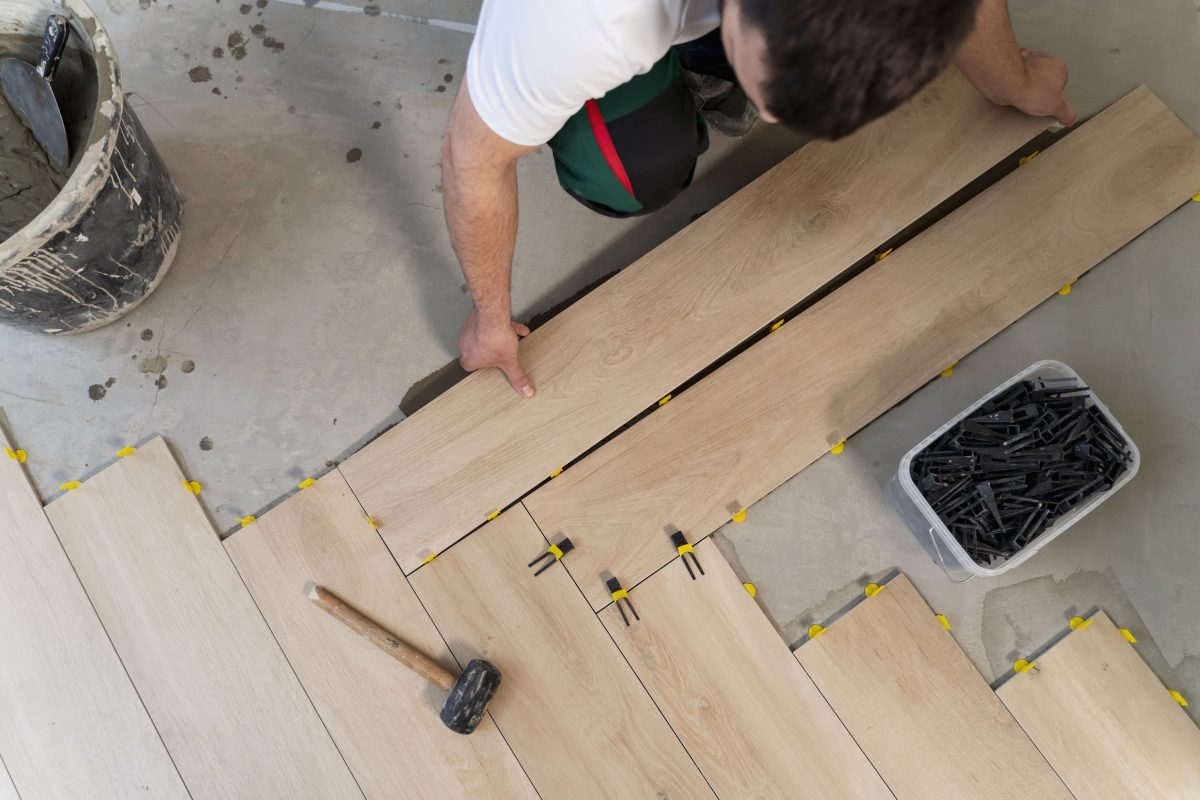top-view-man-tiling-floor-min